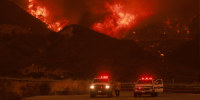 Firefighting personnel monitor the blaze as Highway 330 is engulfed by the Line Fire near Running Springs, California, on Saturday.