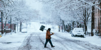 A resident carries a shovel during a storm in Hudson, New York on Jan. 7, 2024. 