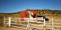 A U.S. flag flies at the entrance to the Bonanza Creek Ranch film set in Sante Fe, N.M., on Oct. 28, 2021.