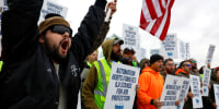 Members of the International Longshoremen's Association union stand outside Maher Terminal on strike in Elizabeth, New Jersey