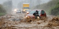 A resident helps free a stranded car as Tropical Storm Helene strikes Boone, North Carolina