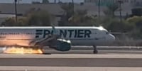 A Frontier flight with flames visible underneath the aircraft at Harry Reid International Airport in Las Vegas.