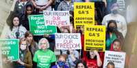 People protest and hold signs advocating for abortion rights