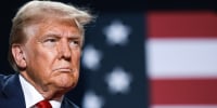 Donald Trump in front of an American flag backdrop