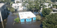 An aerial of 2690 Apartments in floodwater