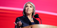 Michelle Lujan Grisham behind a podium on stage