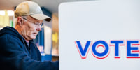 A man votes in a voting booth