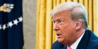 Donald Trump, right, speaks as Mitch McConnell watches on from the left