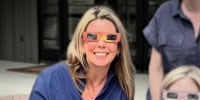 Suzanne Simpson wearing eclipse glasses.