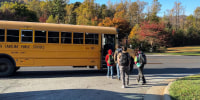 Kids board the bus to return to school in Buncombe County, N.C., on Oct. 24, 2024.