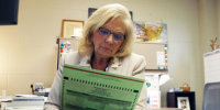 Sheryl Guy looks at a ballot