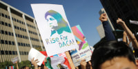 Protesters hold signs as they rally