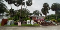 Contents of homes damaged by flooding from Hurricane Helene are piled on the side of the road in Tampa, Fla., ahead of Hurricane Milton.