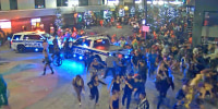 People flee after a shooting in downtown Orlando, Fla., early on Nov. 1, 2024.