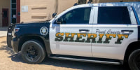 Pinal County Sheriff's Office police car parked outside of a school building