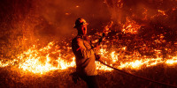 A firefighter battles the Mountain Fire