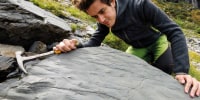 Marco Cattaneo looks at boulder 0, the first boulder found with footprints.