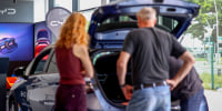 Customers look at electric vehicles.