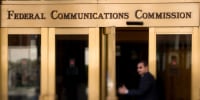 A man walks into the Federal Communications Commission (FCC) headquarters