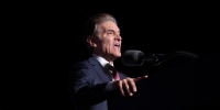 Dr. Mehmet Oz speaks as Donald Trump listens at a rally