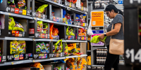 A customer shops for Halloween candy in a grocery aisle