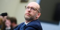 Russell Vought listens during a hearing