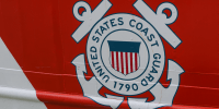 A detail view of the coast guard seal on the side of a ship