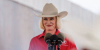 Dawn Buckingham smiles at a podium outdoors