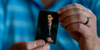 Hector Adames holds a small photo of Joshua Adames.