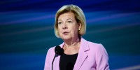 Tammy Baldwin speaks at a podium on stage