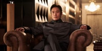 Lee Byung-hun sits on a sofa chair