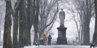 Image: Snow falls as a couple walks along the Commonwealth Avenue Mall in the Back Bay neighborhood of Boston on Dec. 20, 2024.