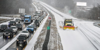 The photo shows vehicles stopped on the westbound side and a plow, headed west, on the eastbound side.