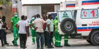 Medics inspect an ambulance of wounded people, shot by armed gangs at the General Hospital