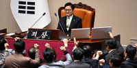 South Korea's ruling People Power Party lawmakers argue with National Assembly Speaker Woo Won-shik over the impeachment of acting president Han Duck-soo at the National Assembly in Seoul on December 27, 2024. 