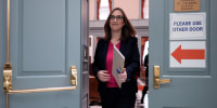 Sarah McBride exits a room between two double doors