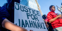 A protester holds a sign calling for justice.