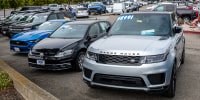 Used vehicles for sale at a dealership parked outside