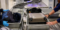 Passengers pass through the TSA checkpoint.