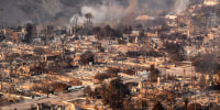 Image: aerial homes destroyed  smoke smolder
