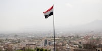 The flag of Yemen on a mountain overlooking Sana'a city