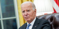 Joe Biden sits at his desk in the oval office