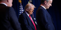 President Donald Trump prays at the National Prayer Breakfast.