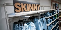 Various skinny jeans on display in the clothing store