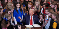 President Donald Trump is joined by female athletes as he signs the "No Men in Women's Sports" executive order at the White House on Feb. 5, 2025.