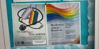 Pride flyers on display inside of a display box