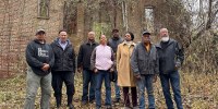 Descendants of Oak Hill sharecroppers stand outside the ruins of the property's once-grand plantation house near Danville, Va.