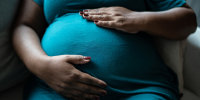 Pregnant woman touching her belly
