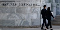 Pedestrians walk towards the Harvard Medical School, Aug. 18, 2022.