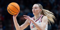 Paige Bueckers passes the ball